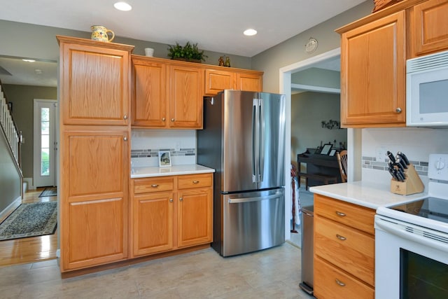 3115 Sable Oaks Rd, Bloomington, IL 61704 - kitchen featuring white appliances, light countertops, and recessed lighting