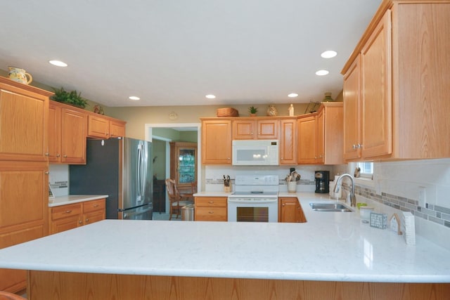 3115 Sable Oaks Rd, Bloomington, IL 61704 - kitchen with white appliances, a peninsula, recessed lighting, and light stone counters