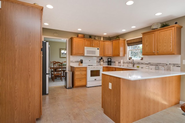 3115 Sable Oaks Rd, Bloomington, IL 61704 - kitchen with white appliances, a peninsula, recessed lighting, light countertops, and tasteful backsplash