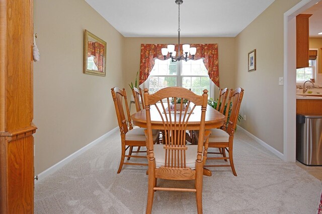 3115 Sable Oaks Rd, Bloomington, IL 61704 - dining area with a chandelier and light colored carpet