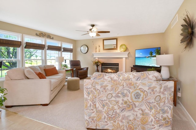 3115 Sable Oaks Rd, Bloomington, IL 61704 - living area with ceiling fan, a glass covered fireplace, and carpet floors