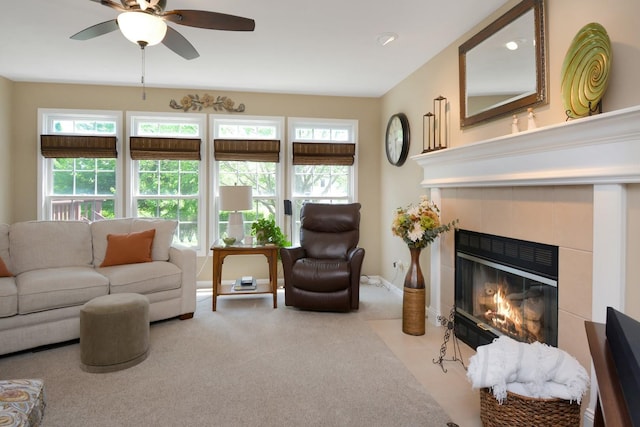 3115 Sable Oaks Rd, Bloomington, IL 61704 - carpeted living room featuring a tiled fireplace and ceiling fan