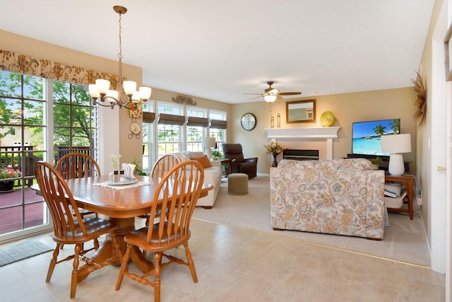 3115 Sable Oaks Rd, Bloomington, IL 61704 - dining room with ceiling fan, a chandelier, and a fireplace