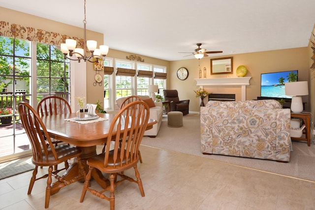 3115 Sable Oaks Rd, Bloomington, IL 61704 - dining room featuring ceiling fan, a chandelier, carpet, and a fireplace