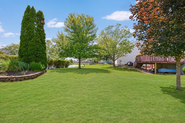 3115 Sable Oaks Rd, Bloomington, IL 61704 - view of grassy yard featuring a deck with water view and stairs