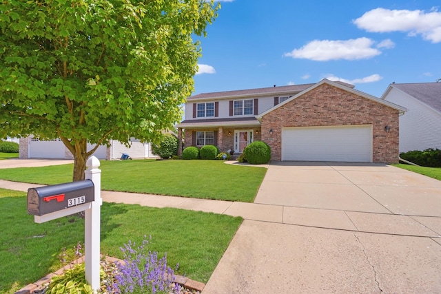 3115 Sable Oaks Rd, Bloomington, IL 61704 - view of front of house with a garage, brick siding, a front yard, and driveway