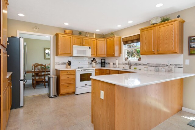 3115 Sable Oaks Rd, Bloomington, IL 61704 - kitchen with white appliances, a peninsula, backsplash, light countertops, and recessed lighting
