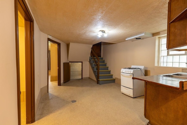 kitchen featuring gas range gas stove and a textured ceiling