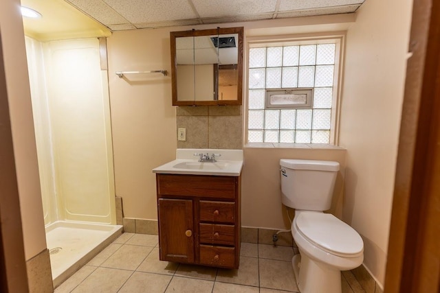 full bath with tile patterned flooring, a shower stall, vanity, and a drop ceiling