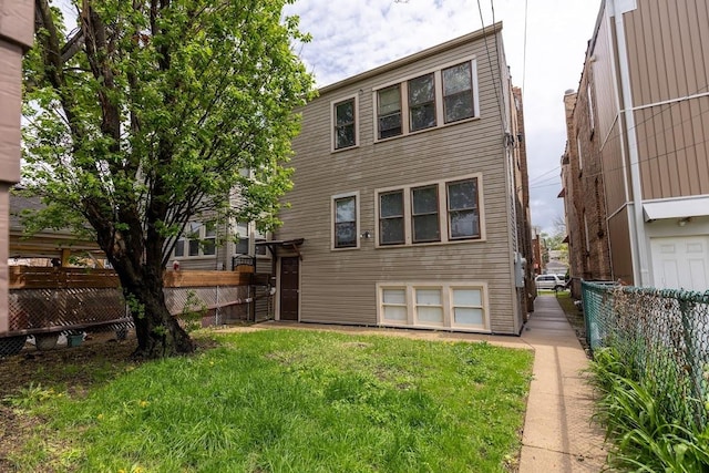 back of house with a fenced backyard