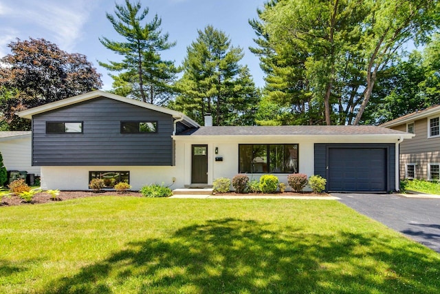 222 S Maple St, Palatine, IL 60067 - split level home featuring driveway, an attached garage, a chimney, and a front lawn