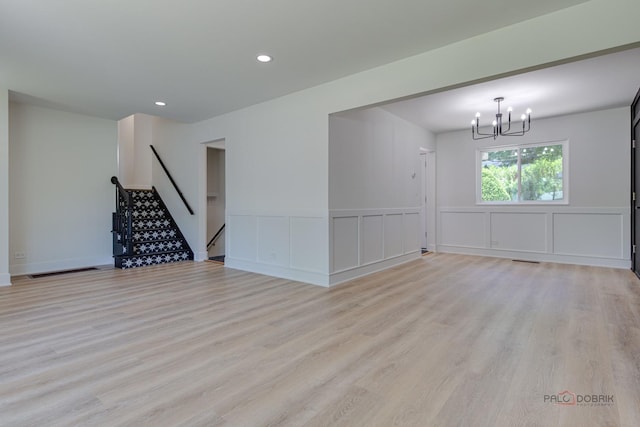 222 S Maple St, Palatine, IL 60067 - spare room with a chandelier, light wood-style flooring, wainscoting, a decorative wall, and stairs