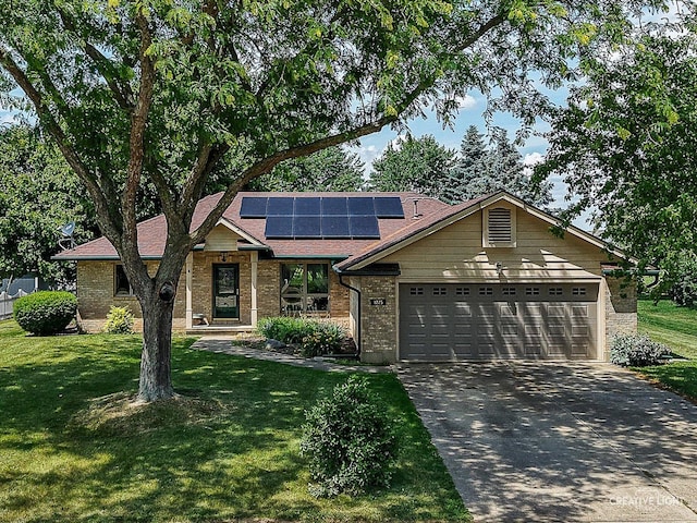 1225 Whitetail Ln, Sandwich, IL 60548 - view of front of home with a front yard, driveway, roof mounted solar panels, and brick siding