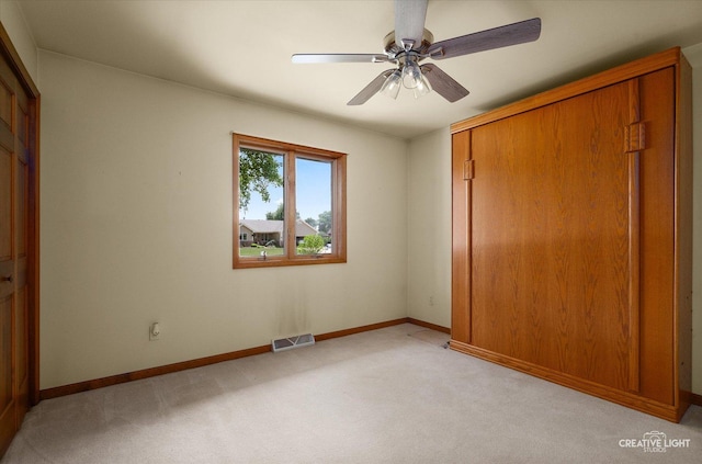 1225 Whitetail Ln, Sandwich, IL 60548 - unfurnished bedroom featuring light carpet, a closet, and a ceiling fan
