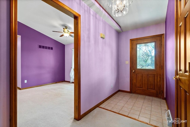 1225 Whitetail Ln, Sandwich, IL 60548 - entrance foyer featuring a chandelier, vaulted ceiling, a ceiling fan, light carpet, and light tile patterned floors