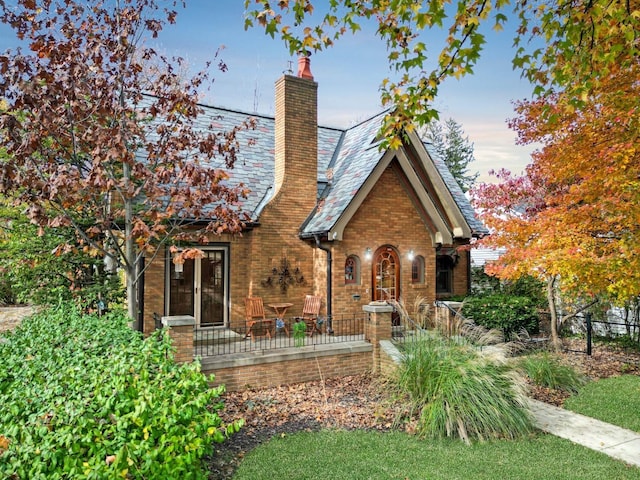 9 Harwood Pl, Bloomington, IL 61701 - view of front facade featuring a chimney, brick siding, and a high end roof
