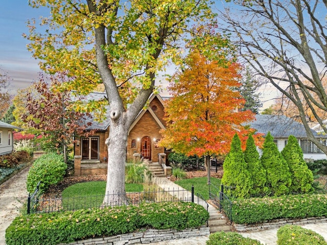 9 Harwood Pl, Bloomington, IL 61701 - view of front facade with a fenced front yard and brick siding
