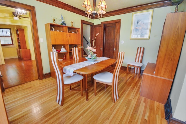 9 Harwood Pl, Bloomington, IL 61701 - dining space featuring light wood-style floors, a chandelier, ornamental molding, and ceiling fan