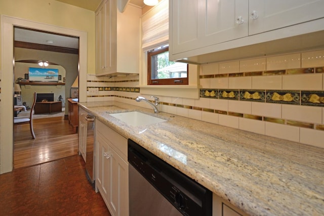 9 Harwood Pl, Bloomington, IL 61701 - kitchen featuring stainless steel dishwasher, a fireplace, backsplash, and white cabinets