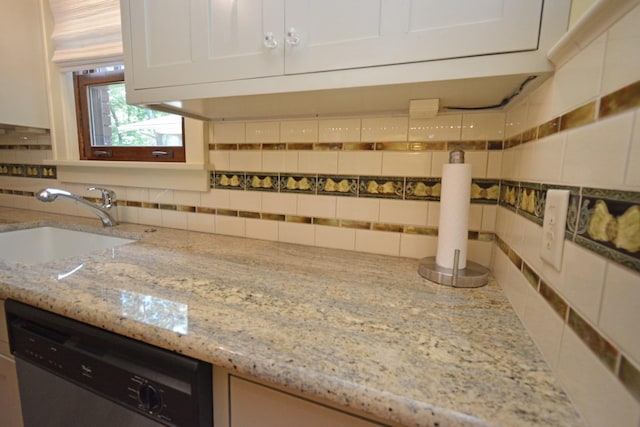9 Harwood Pl, Bloomington, IL 61701 - kitchen featuring stainless steel dishwasher, decorative backsplash, light stone countertops, and white cabinetry