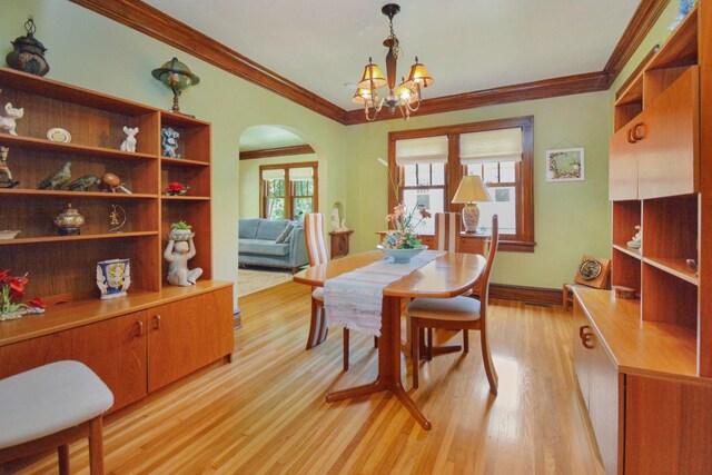 9 Harwood Pl, Bloomington, IL 61701 - dining room with arched walkways, light wood-type flooring, crown molding, and a chandelier