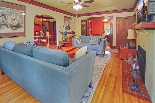 9 Harwood Pl, Bloomington, IL 61701 - living area featuring arched walkways, light wood-style floors, ceiling fan, and crown molding