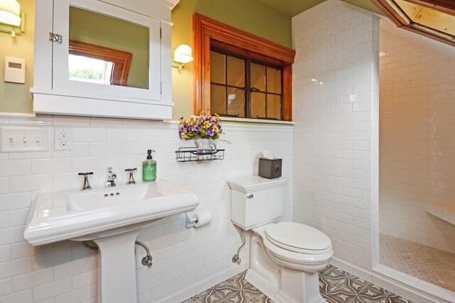 9 Harwood Pl, Bloomington, IL 61701 - full bathroom with tile walls, tiled shower, and tile patterned floors
