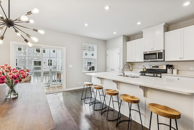 53 Nicholas Dr E, Des Plaines, IL 60016 - kitchen with stainless steel appliances, dark wood-style floors, recessed lighting, light countertops, and a chandelier