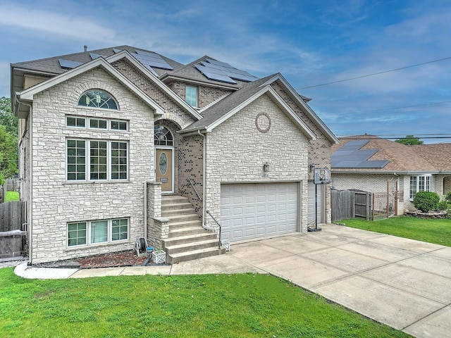 4914 W 82nd St, Burbank, IL 60459 - view of front of property featuring stone siding, driveway, solar panels, a garage, and roof with shingles