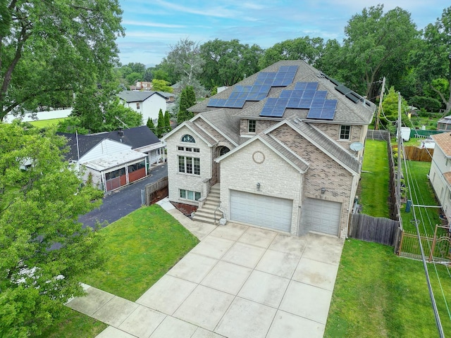 4914 W 82nd St, Burbank, IL 60459 - view of front facade with roof with shingles, concrete driveway, roof mounted solar panels, an attached garage, and brick siding