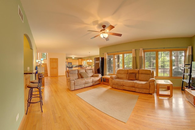 4914 W 82nd St, Burbank, IL 60459 - living room featuring a ceiling fan, arched walkways, and light wood-type flooring