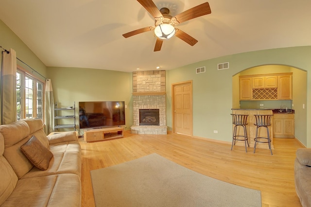 4914 W 82nd St, Burbank, IL 60459 - living area with light wood finished floors, ceiling fan, a fireplace, and bar