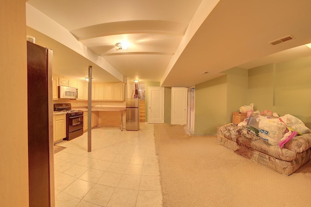 4914 W 82nd St, Burbank, IL 60459 - finished below grade area with freestanding refrigerator, fridge, and light tile patterned flooring