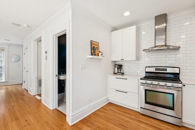 2118 W Schiller St Unit Ch, Chicago, IL 60622 - kitchen featuring wall chimney exhaust hood, stainless steel gas range, crown molding, light countertops, and backsplash