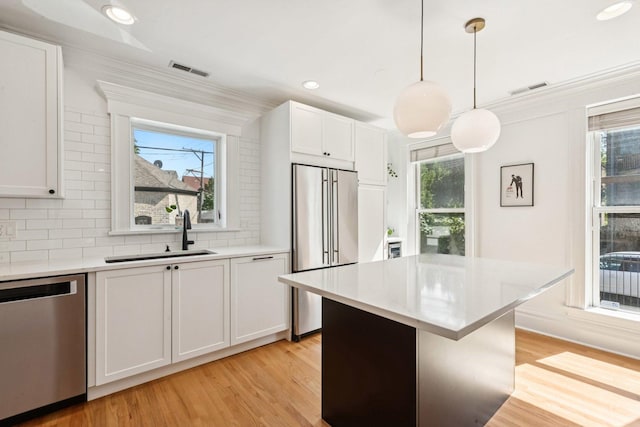 2118 W Schiller St Unit Ch, Chicago, IL 60622 - kitchen with appliances with stainless steel finishes, light wood-style flooring, white cabinets, light countertops, and recessed lighting