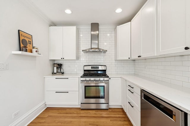 2118 W Schiller St Unit Ch, Chicago, IL 60622 - kitchen featuring wall chimney range hood, appliances with stainless steel finishes, white cabinetry, backsplash, and light stone countertops