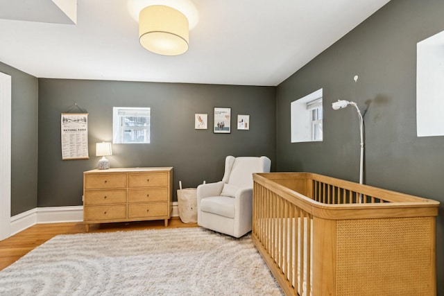 2118 W Schiller St Unit Ch, Chicago, IL 60622 - bedroom with a nursery area, multiple windows, and wood finished floors