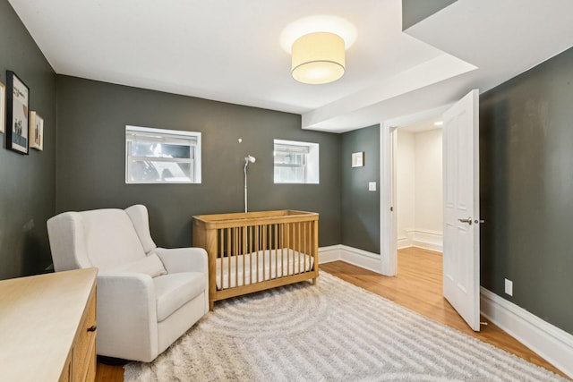 2118 W Schiller St Unit Ch, Chicago, IL 60622 - bedroom with light wood-style floors and a crib