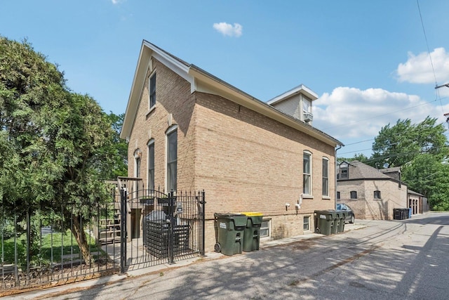 2118 W Schiller St Unit Ch, Chicago, IL 60622 - view of side of home with a gate and brick siding