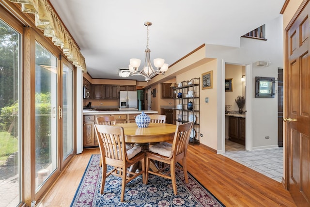 1304 Sheffield Ct, Carol Stream, IL 60188 - dining space with a chandelier and light wood-style floors