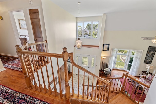 1304 Sheffield Ct, Carol Stream, IL 60188 - staircase featuring wood finished floors, healthy amount of natural light, and a chandelier
