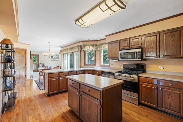 1304 Sheffield Ct, Carol Stream, IL 60188 - kitchen featuring appliances with stainless steel finishes, light countertops, a chandelier, a peninsula, and a kitchen island