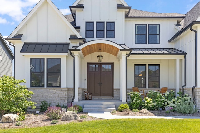 4216 Carpenter Rd, Naperville, IL 60564 - modern farmhouse style home featuring a standing seam roof, board and batten siding, stone siding, covered porch, and roof with shingles