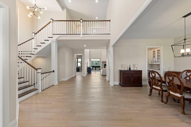 4216 Carpenter Rd, Naperville, IL 60564 - dining room with a chandelier, light wood-style floors, stairs, a towering ceiling, and recessed lighting