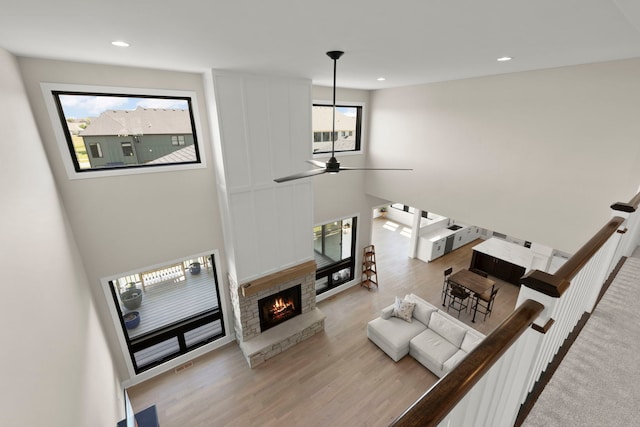 4216 Carpenter Rd, Naperville, IL 60564 - living room with wood finished floors, healthy amount of natural light, recessed lighting, a stone fireplace, and ceiling fan