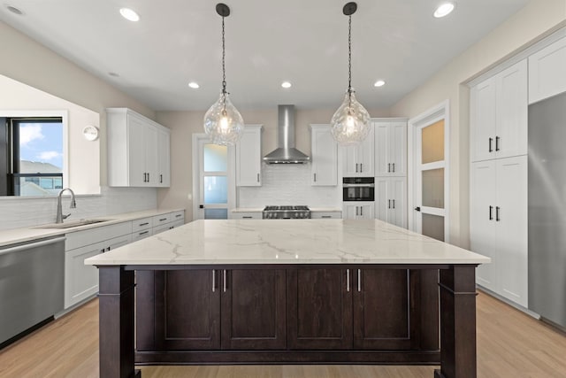 4216 Carpenter Rd, Naperville, IL 60564 - kitchen with wall chimney range hood, appliances with stainless steel finishes, backsplash, white cabinetry, and a kitchen island