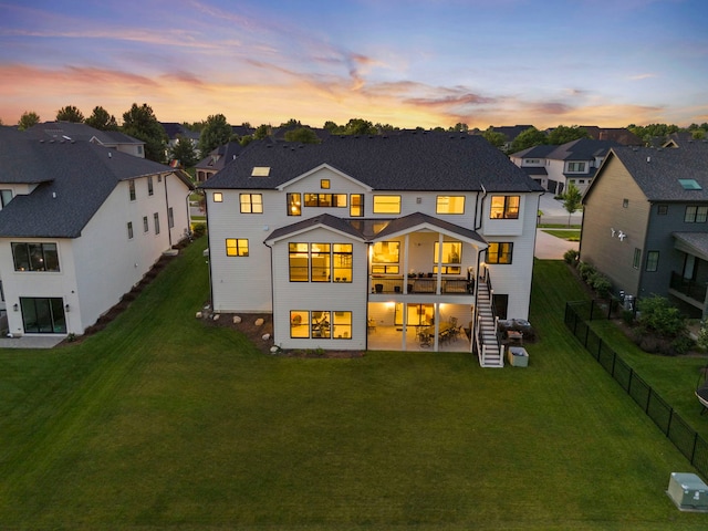 4216 Carpenter Rd, Naperville, IL 60564 - back of property at dusk with a residential view, stairs, a fenced backyard, and a patio area