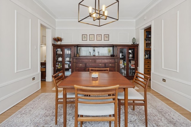 5245 N Winthrop Ave Unit 3S, Chicago, IL 60640 - dining area with light wood finished floors, ornamental molding, and a chandelier