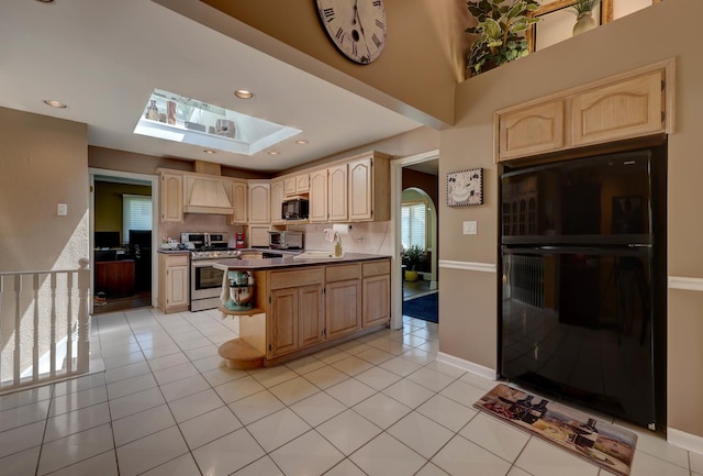 1213 Rose Ct, Bartlett, IL 60103 - kitchen with black appliances, light brown cabinetry, a skylight, custom exhaust hood, and light tile patterned flooring