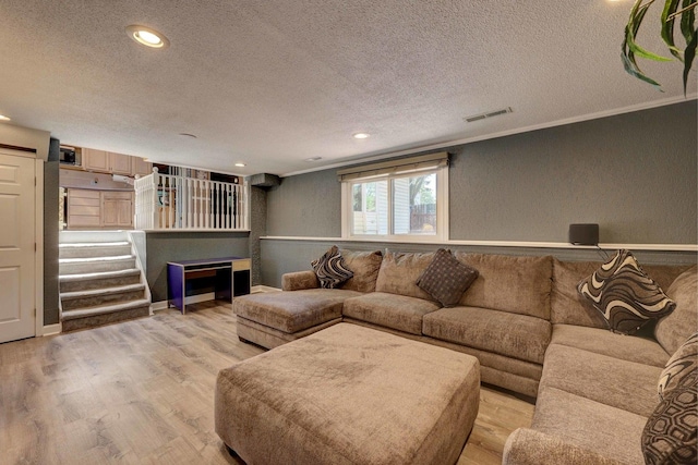 1213 Rose Ct, Bartlett, IL 60103 - living area featuring a textured ceiling, light wood finished floors, crown molding, recessed lighting, and a textured wall